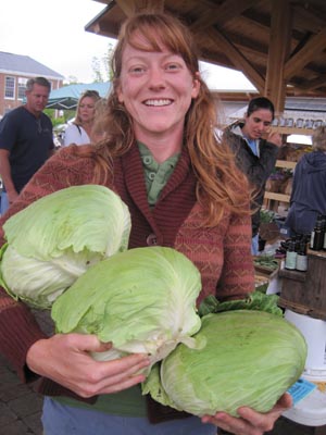 Kim holding some impressive cabbages at market!